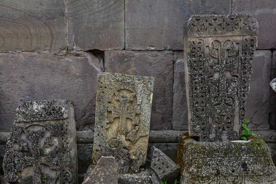 Old Armenian khachkars. Cross on a rock. Stone with a cross.