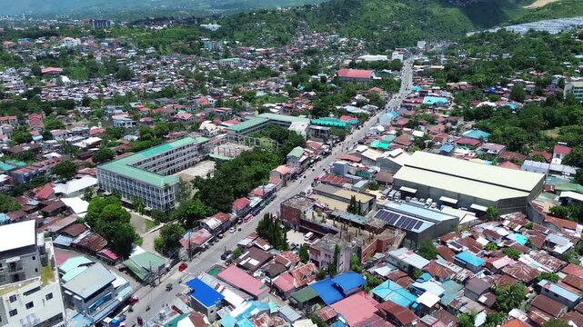 Drone aerial footage of urban residential neighborhoods and city buildings in Talisay, Cebu, Philippines.