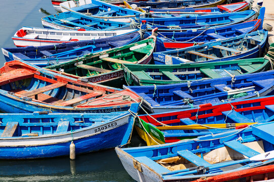 Setubal, Portugal, August 14, 2025. A dense cluster of colorful traditional Portuguese fishing boats moored at the pier in the city of Setubal.