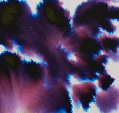Ink blending and diffusing on paper creating a vibrant, abstract background with shades of purple, blue, pink, and dark green, showing a watercolor effect