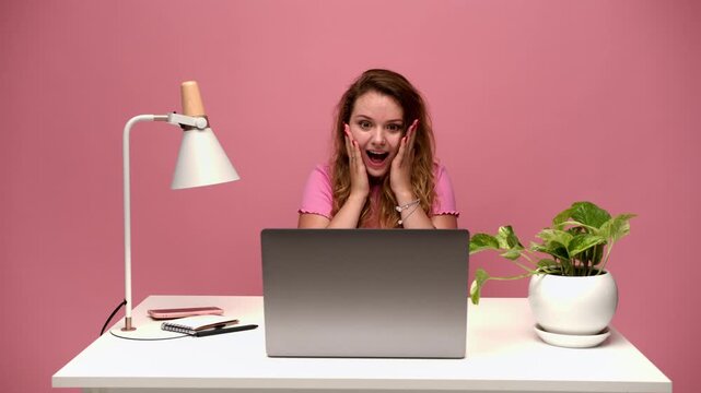 Stressed freelancer showing a wide range of emotions from desperation to excitement while working on her laptop