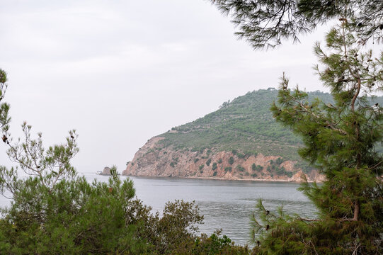 Coastal landscape with tranquil bay beneath sky