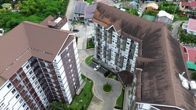 Drone aerial footage of urban residential neighborhoods and city buildings in Talisay, Cebu, Philippines.