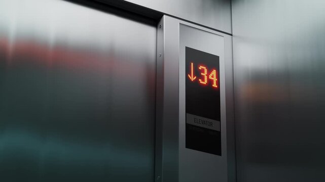 High-rise building elevator descending, floor numbers displayed on control panel