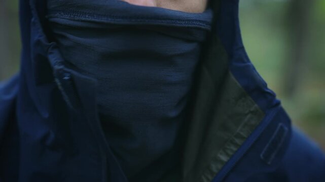 Pulling Up Buff and Hood in Rain &ndash; Outdoor Storm Preparation Close Up