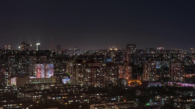 The modern urban nightscape formed by the lights of countless homes in Beijing's densely populated residential areas and landmarks in the CBD.
