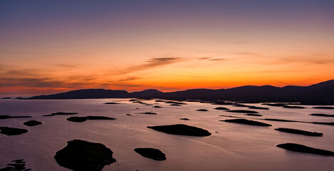 Obraz premium Aerial sunset view over Clew Bay near Westport, County Mayo, Ireland. Scenic Atlantic bay with drumlin islands and mountain silhouettes on the Wild Atlantic Way.