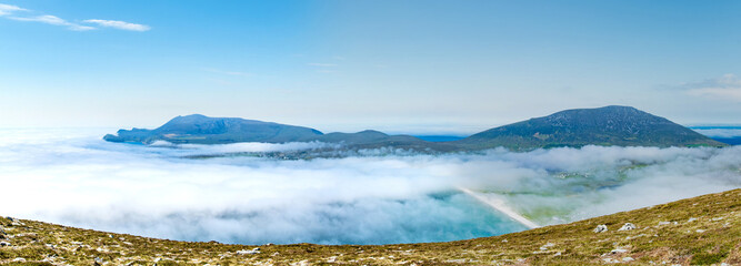 Obraz premium View from Minaun Heights over Keel Beach on Achill Island, County Mayo, Ireland. Turquoise Atlantic bay, white sand and low clouds on the Wild Atlantic Way.