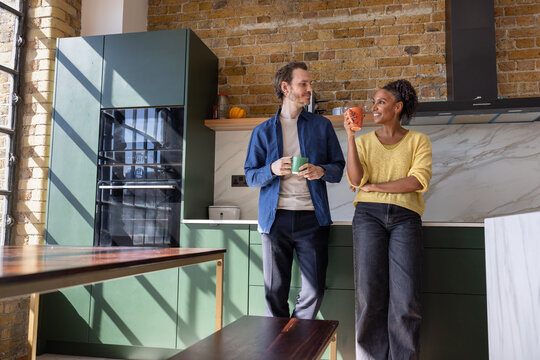 Couple Sharing a Warm Moment in Modern Kitchen