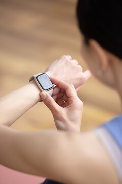 Close Up of Smartwatch on Woman's Wrist Wearing Yoga Wear