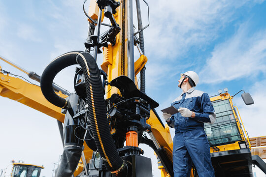 Offshore worker inspect with tablet drilling rig for exploration of minerals for oil, gas and artisan water. Concept smart online Industry