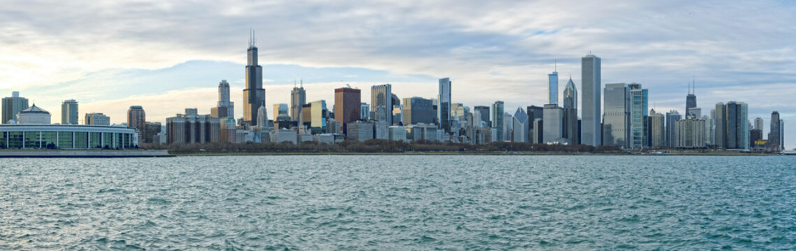 The sprawling Chicago skyline as seen across the choppy waters of Lake Michigan under a cool, overcast sky.