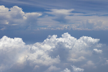 Fototapeta premium A stunning aerial view showcasing towering cumulus clouds against a brilliant blue sky. This image captures the beauty and scale of atmospheric formations.