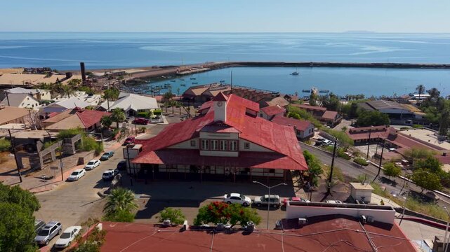 Discover Santa Rosalia in Baja California Sur with aerial views showcasing its buildings and harbor against the ocean and landscape