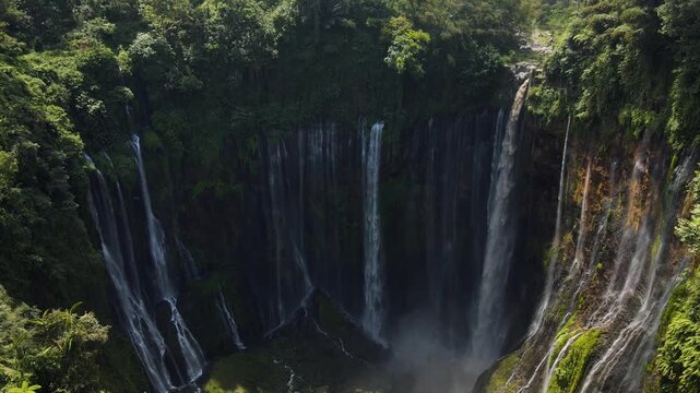 Stunning 4K aerial view of Tumpak Sewu waterfall curtains in East Java, Indonesia.