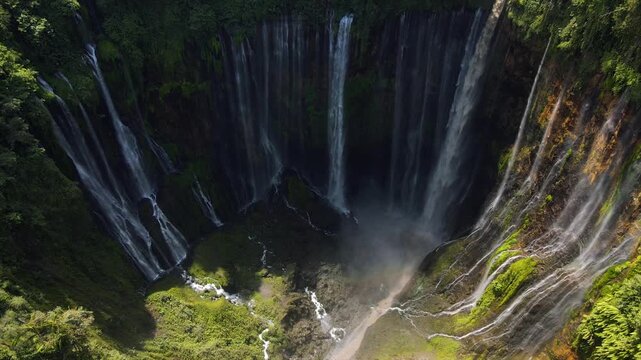 Stunning 4K aerial view of Tumpak Sewu waterfall curtains in East Java, Indonesia.