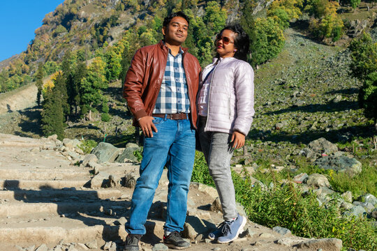 Portrait shot of a young Indian couple enjoying in the beautiful hills of Chandanwari, is the Gateway of the Holy Amarnath Yatra at Pahalgam, Kashmir, India.