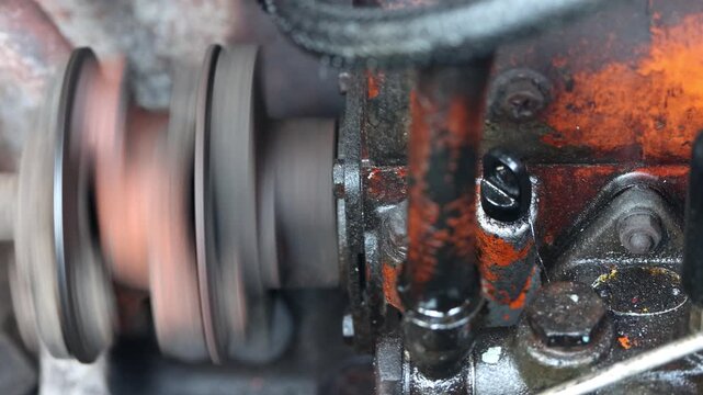 Close-up of a greasy and rusty diesel engine on a public river boat