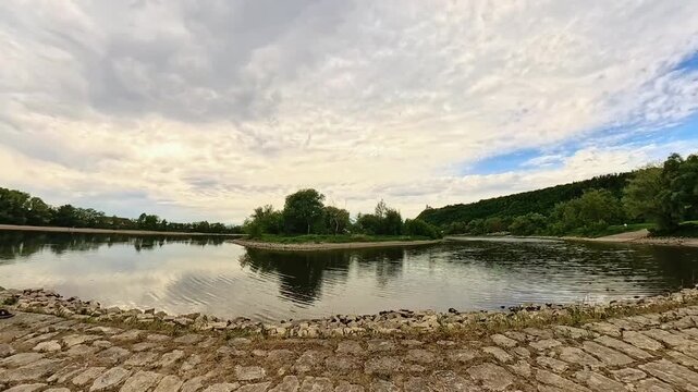 4K Timelapse video with moving waters of river danube and moving clouds near Bogen, Straubing, Bavaria, Germany