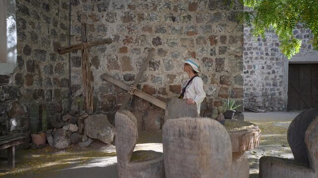 Mature woman enjoys her visit to Mission Church in San Ignacio, Baja California, discovering the history and culture of the area.