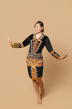 Beautiful young kadazandusun native female in her traditional costume in isolated background