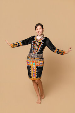 Beautiful young kadazandusun native female in her traditional costume in isolated background