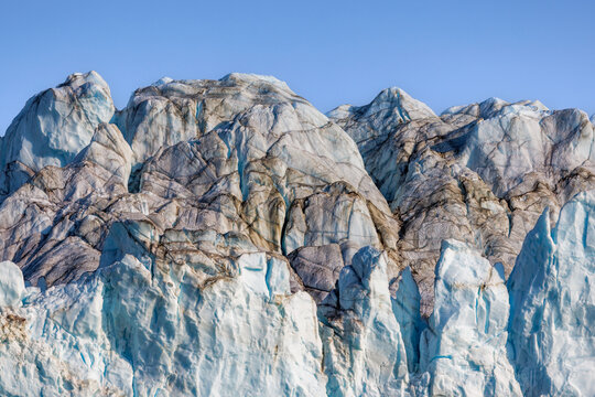 The terminus of the Jaette, or Jatte glacier, in Isfjord, Northeast Greenland National Park. The Greenland ice sheet is the largest ice mass in the Northern hemisphere. Blue sky with copyspace.