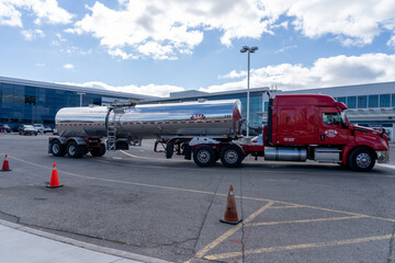 Fototapeta premium Toronto, Canada - October 16, 2024: A BTL tank truck at Billy Bishop Toronto City Airport on Toronto Islands in Toronto, Ontario, Canada. Bridgeland Terminals (BTL) is a Tank Truck Transportation co