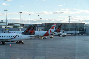 Fototapeta premium Mississauga, ON, Canada - October 16, 2024: Air Canada planes parked at Toronto’s Pearson International Airport in Mississauga, ON, Canada. 