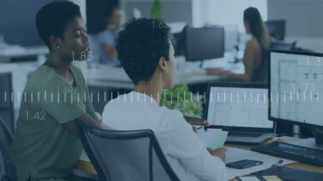 Coworkers reviewing business charts on monitors, colleague pointing activating timelines for action