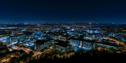 Obraz premium Stunning Aerial Night View of Modern Urban Metropolis Skyline - Illuminated Cityscape with Vibrant City Lights at Dusk