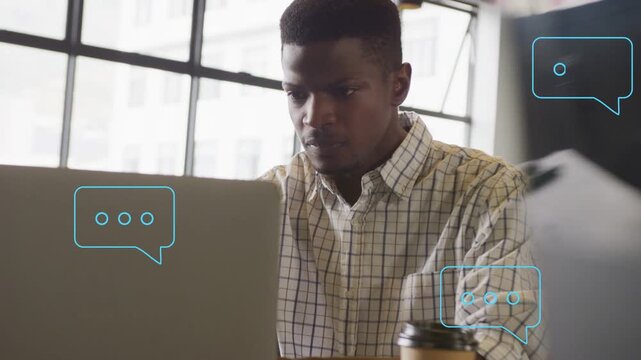 Incoming chat bubbles appearing at laptop, man reaching for coffee then typing for remote work