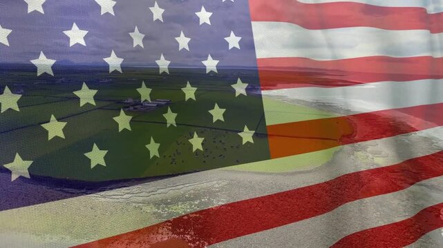 Sunlight initiating US flag overlay rippling while aerial panning left, revealing tidal channels