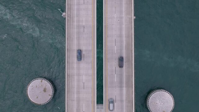 Overhead aerial drone shot of traffic crossing the Sunshine Skyway Bridge