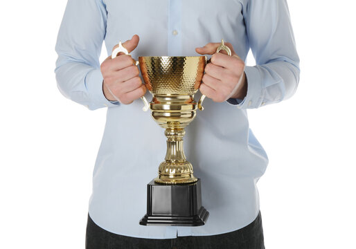 Man in blue shirt holding gold trophy cup, winner award concept isolated on transparent background PNG