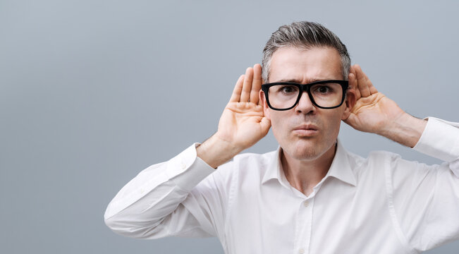 Man listening to a loud noise
