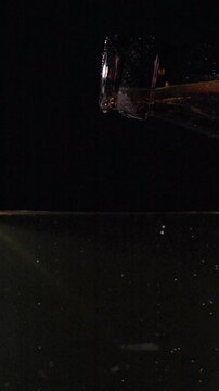 Pouring Craft Beer Into a Glass in Slow Motion Showcasing Bubbles and Foam in 1000 Fps on a Dark Background