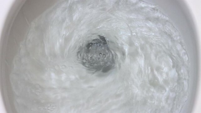 The flushing process in the toilet bowl, top view