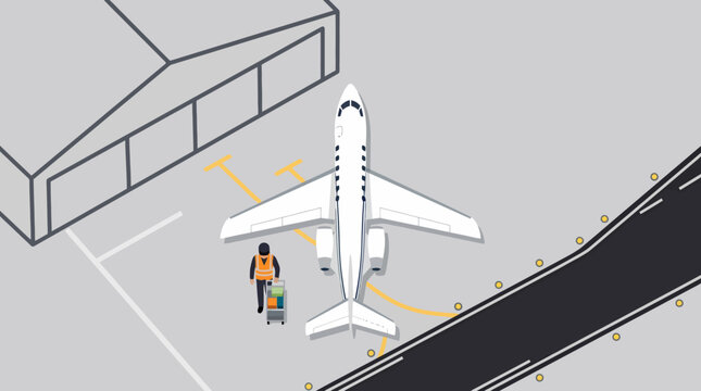 An airport ground crew member working near a private jet airplane.