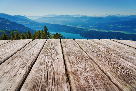 A real, physical table set against a mountain panorama background.