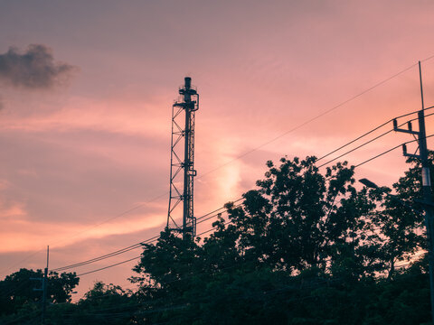 Silhouette of a petrochemical refinery flare stack against a beautiful twilight sky, Thailand.