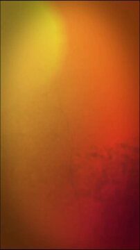 A warm gradient of yellow, orange, and red blends across a textured surface, evoking feelings of sunset, fire, and aged beauty, creating a vibrant backdrop.