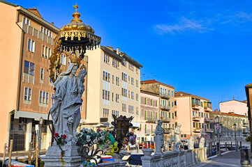 Religious statue of Madonna and Child with golden canopy on a canal bridge in Chioggia © goce risteski