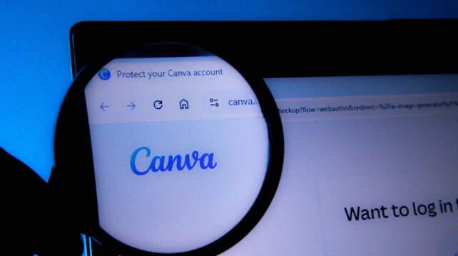 Magnifying glass over a laptop screen showing the canva login page and account security prompt
