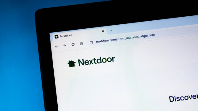 Closeup of a laptop screen displaying the nextdoor website homepage in a web browser