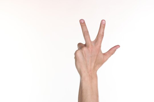 Man showing number three with fingers on white background, closeup. Space for text