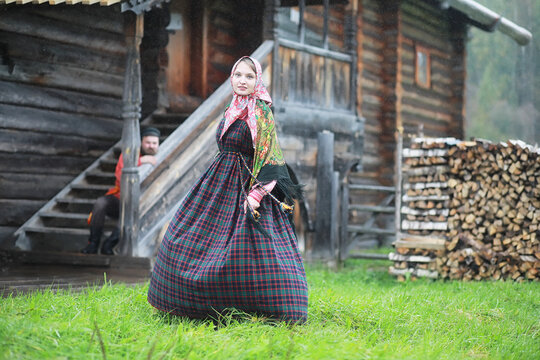 Traditional Slavic rituals in the rustic style. Outdoor in summer. Slavic village farm. Peasants in elegant robes.