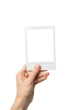 Hand holding a blank polaroid photo frame isolated on transparent background