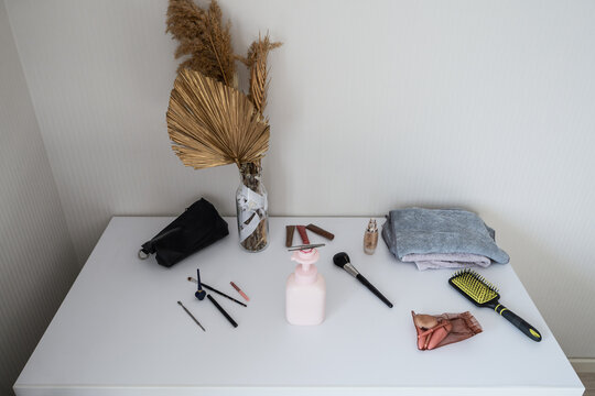 High angle view of makeup products on a white table
