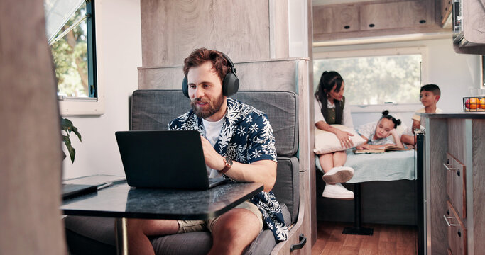 Laptop, headphones and man in camper van with family for travel blog, copywriting and remote work. Freelance, computer and person with music for tourist guide, research and internet for nomad living
